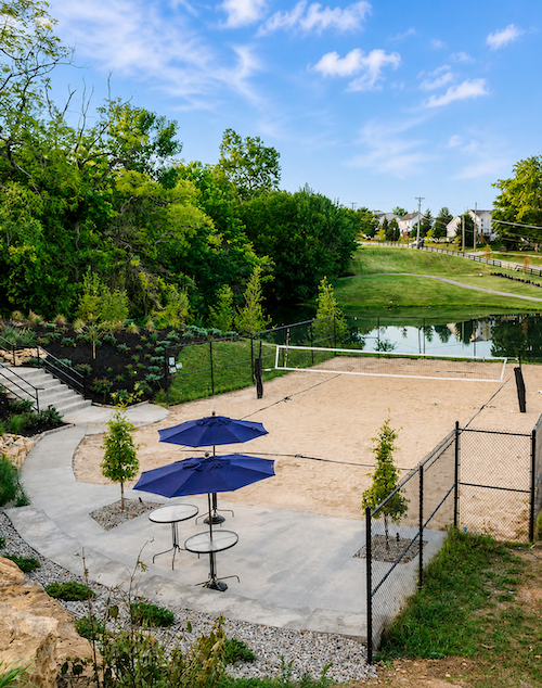 sand volleyball court with view of pond